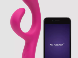 We-Vibe Nova sex toy in pink with app on mobile phone next to it